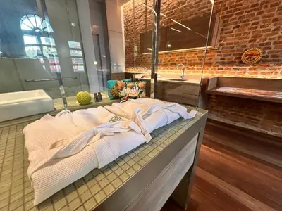 a bathroom with towels on a counter with a sink at Loke Thye Kee Heritage Suite Hotel's in Gua Sai