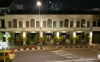 a building with a parking lot in front of it at night at Loke Thye Kee Heritage Suite Hotel's in Gua Sai