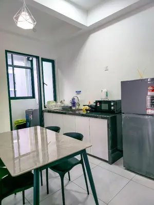 a kitchen with a wooden table and a counter top at Spacious Luxury Home 3BR 2BA 14pax in George Town