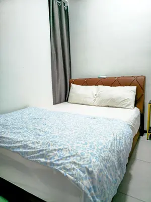 a bedroom with a bed with a blue comforter at Spacious Luxury Home 3BR 2BA 14pax in George Town
