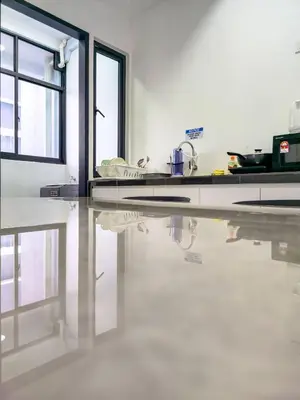 a kitchen with a reflection of a sink in the floor at Spacious Luxury Home 3BR 2BA 14pax in George Town