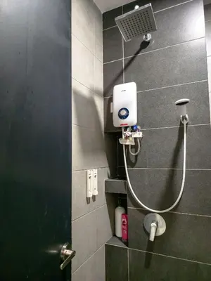 a shower in a bathroom with a shower head at Spacious 3BR Seaview Home 10pax a29 in George Town