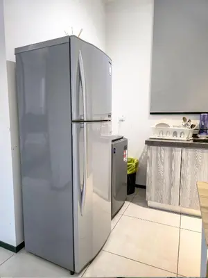 a stainless steel refrigerator in a kitchen at Spacious 3BR Seaview Home 10pax a29 in George Town