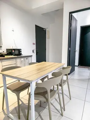 a wooden table and chairs in a kitchen at Spacious 3BR Seaview Home 10pax a29 in George Town
