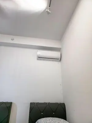 a room with a couch and a light on the ceiling at Spacious 3BR Seaview Home 10pax a29 in George Town