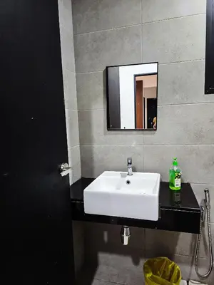 a bathroom with a white sink and a mirror at Premium Coastal Haven Beautiful Seaview 12Pax b29 in George Town
