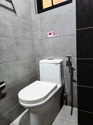 a bathroom with a toilet with a sign on the wall at Premium Coastal Haven Beautiful Seaview 12Pax b29 in George Town