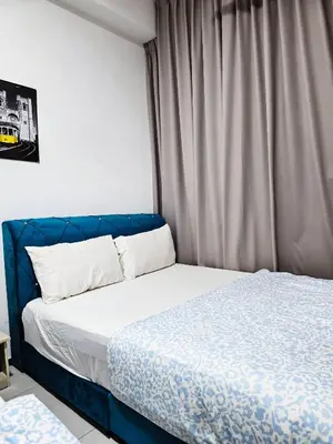 a bed with a blue headboard in a bedroom at Premium Coastal Haven Beautiful Seaview 12Pax b29 in George Town