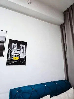 a room with a blue couch and a picture on the wall at Premium Coastal Haven Beautiful Seaview 12Pax b29 in George Town