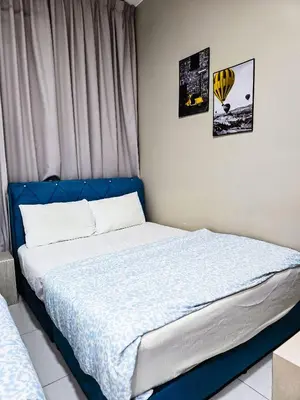 a bed with a blue headboard in a bedroom at Premium Coastal Haven Beautiful Seaview 12Pax b29 in George Town