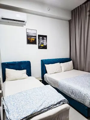 a room with two beds and a window at Premium Coastal Haven Beautiful Seaview 12Pax b29 in George Town