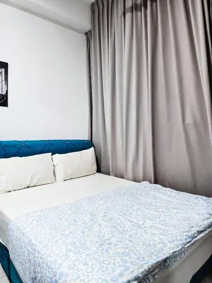 a bed in a room with a curtain at Premium Coastal Haven Beautiful Seaview 12Pax b29 in George Town