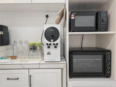 a kitchen counter with a microwave and a microwave at I-homey Residence 1 in Gua Sai
