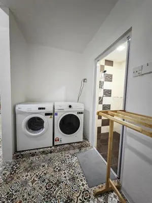 a washer and dryer sitting in a room at I-homey Residence 1 in Gua Sai