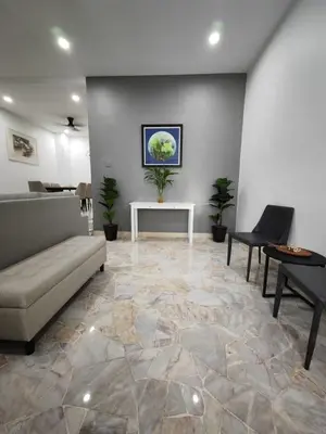 a living room with a couch and a table at I-homey Residence 1 in Gua Sai