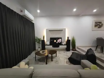 a living room with a couch and a table at I-homey Residence 1 in Gua Sai