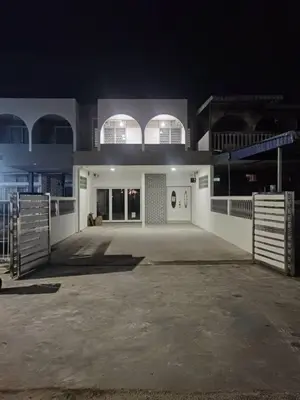 a large white building with two windows at night at I-homey Residence 1 in Gua Sai
