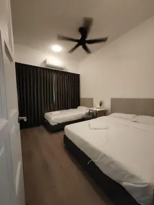 a bedroom with two beds and a ceiling fan at I-homey Residence 1 in Gua Sai