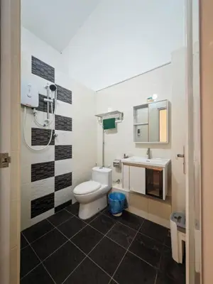 a bathroom with a toilet and a sink at I-homey Residence 1 in Gua Sai