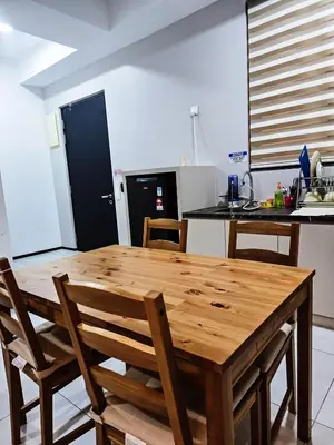 a kitchen with a wooden table and chairs in a kitchen at High Floor sea view 12 pax 3BR luxury suites b29 in Jelutong