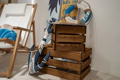 a stack of wooden drawers next to a chair at By The Sea Haven 2BR 6pax in Batu Ferringhi