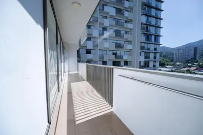 a balcony with a view of a building at By The Sea Haven 2BR 6pax in Batu Ferringhi