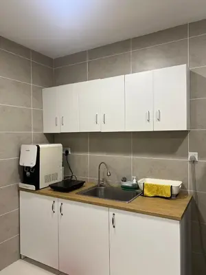 a kitchen with white cabinets and a sink at Sunway Onsen superb view 4-6 pax in Tambun