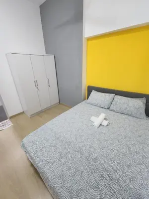 a bedroom with a bed with a white object on it at Praicon Tower Hotel Large Suite 3BR - Butterworth in Butterworth