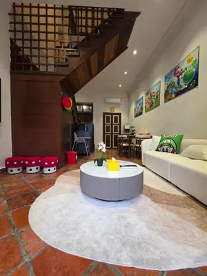 a living room with a couch and a table at New ! 6 Pax Super Mario Georgetown Heritage Pre-war House 2 Bedroom in George Town