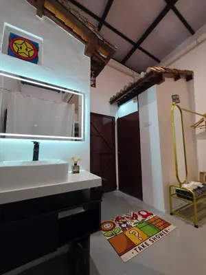 a bathroom with a white sink and a mirror at New ! 6 Pax Super Mario Georgetown Heritage Pre-war House 2 Bedroom in George Town