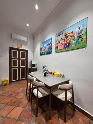 a dining room with a table and four chairs at New ! 6 Pax Super Mario Georgetown Heritage Pre-war House 2 Bedroom in George Town