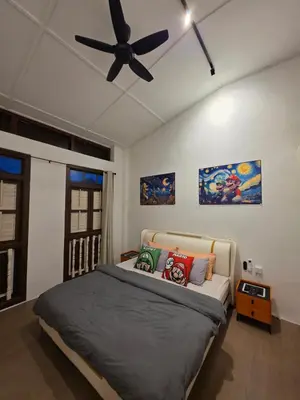 a bedroom with a bed with a ceiling fan at New ! 6 Pax Super Mario Georgetown Heritage Pre-war House 2 Bedroom in George Town