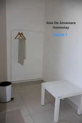 a white table and a hanger in a room at Alaa De Amansara Homestay in Kepala Batas