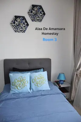 a bedroom with a blue bed with two pillows at Alaa De Amansara Homestay in Kepala Batas