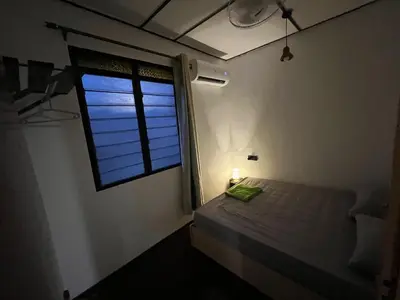 a small bedroom with a bed and a window at Menglembu Ipoh Homestay M21 Smart TV & WiFi ready in Ipoh