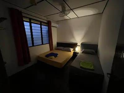 a small room with two beds and a window at Menglembu Ipoh Homestay M21 Smart TV & WiFi ready in Ipoh