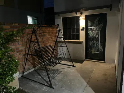 a wrought iron chair sitting in front of a door at Menglembu Ipoh Homestay M21 Smart TV & WiFi ready in Ipoh