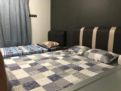 a bedroom with two beds with a quilt on it at Ipoh Menglembu M35 Smart TV & Wifi ready in Ipoh
