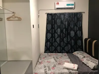 a bedroom with a bed with a black curtain at Ipoh Menglembu M35 Smart TV & Wifi ready in Ipoh