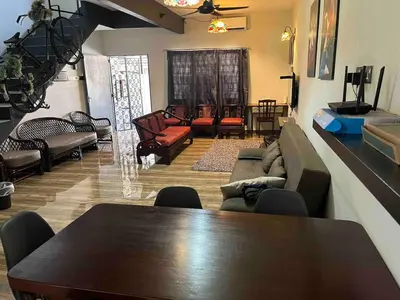 a room with a table and chairs and a living room at Ipoh Menglembu M35 Smart TV & Wifi ready in Ipoh