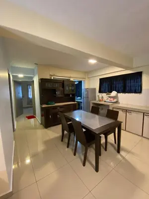 a large kitchen with a table and chairs in it at Rayyan'Homestay DESA in Tanah Rata