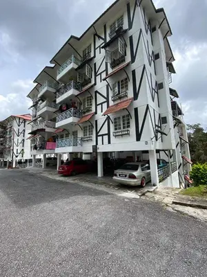 a large building with cars parked in front of it at Rayyan'Homestay DESA in Tanah Rata