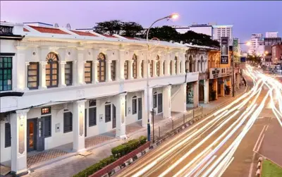 a city street with buildings and traffic at night at Loke Thye Kee Heritage Hotel in George Town