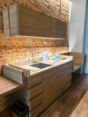a kitchen with a sink and a brick wall at Loke Thye Kee Heritage Hotel in George Town