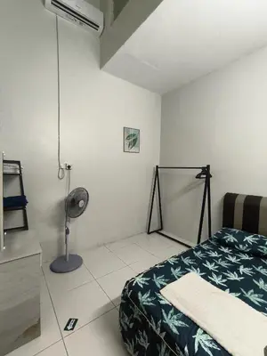 a bedroom with a bed and a lamp in it at Homestay Rumah Iman in Kamunting