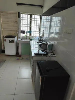 a small kitchen with a sink and a stove at Homestay Rumah Iman in Kamunting