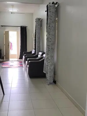 a room with couches and curtains on the wall at Homestay Rumah Iman in Kamunting