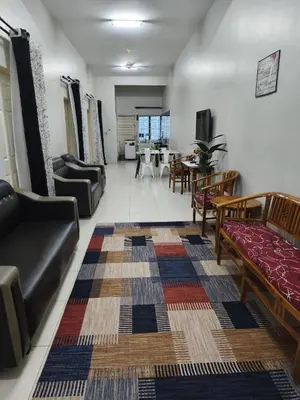 a living room with couches and a dining room at Homestay Rumah Iman in Kamunting