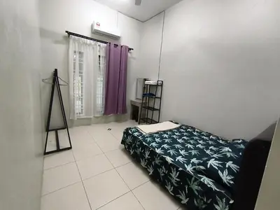 a bedroom with a bed and a purple curtain at Homestay Rumah Iman in Kamunting