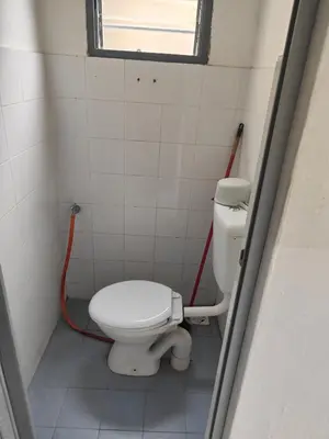 a bathroom with a white toilet in a stall at Margosa Homestay in Ipoh